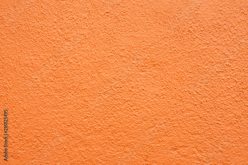 Stucco wall - Orange stucco textured wall background with natural light.