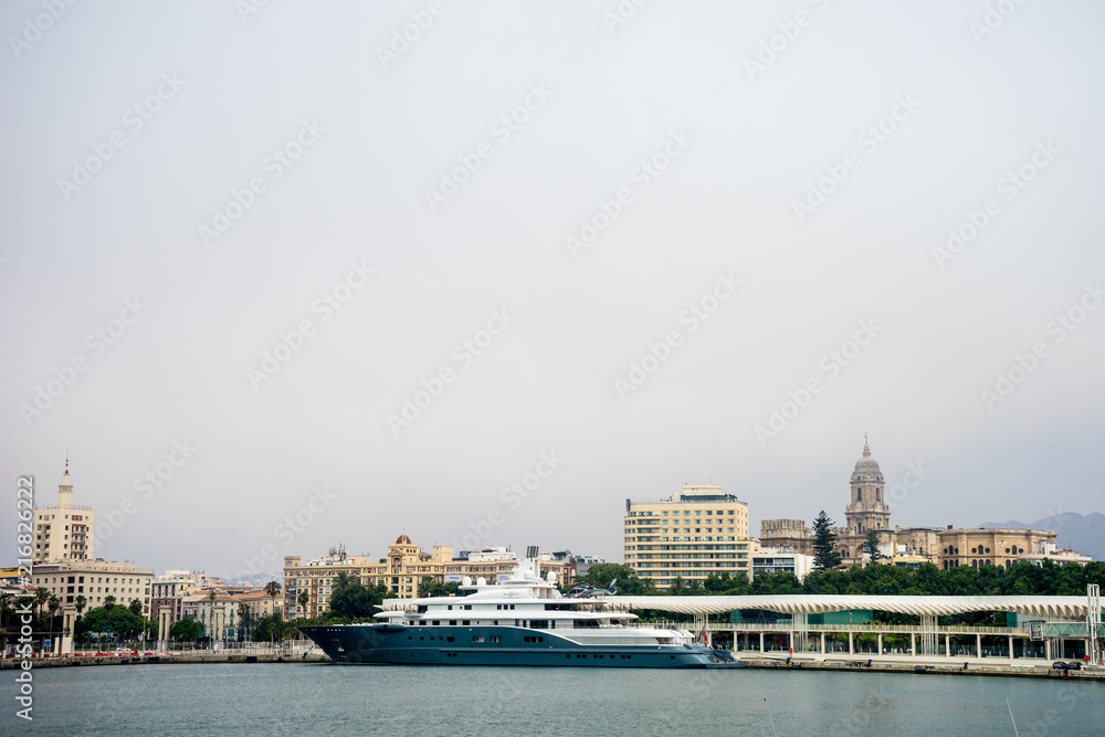 Spain, Malaga, a ship in the harbour with the cathedral in the background