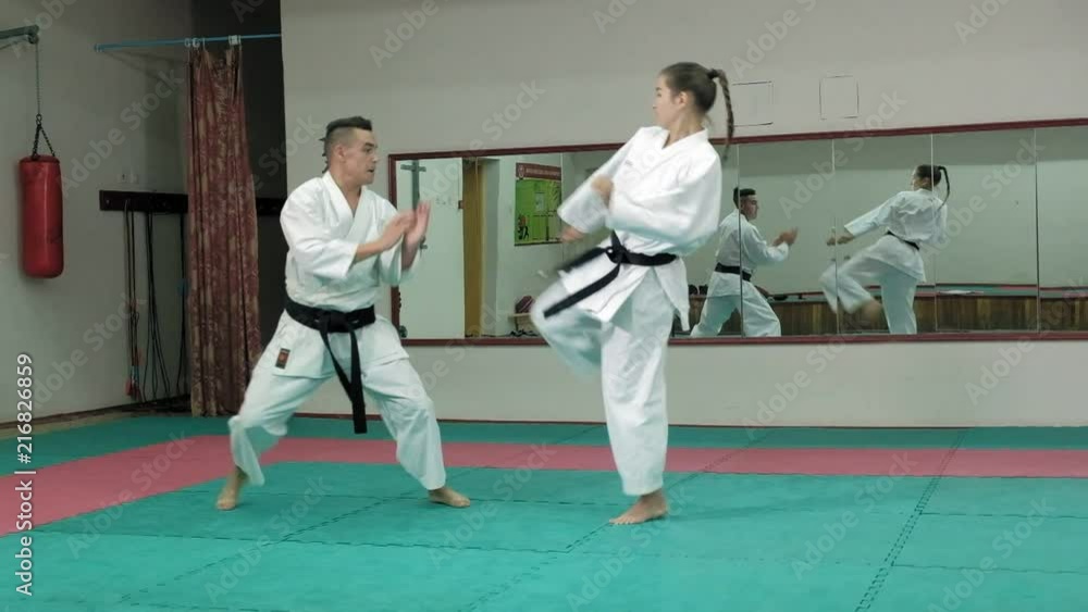 A young man with a muscular body and a woman practicing martial arts Goju-Ryu Karate-Do super slow motion A young man with a muscular body and a woman practicing martial arts Goju-Ryu Karate-Do super slow motion