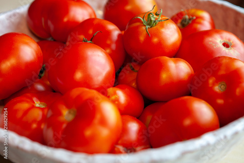 A bowl of homegrown ecological tomatoes. Soft focussed close up shot.