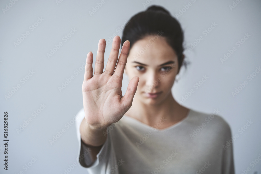 Young girl showing stop gesture Young girl showing stop gesture