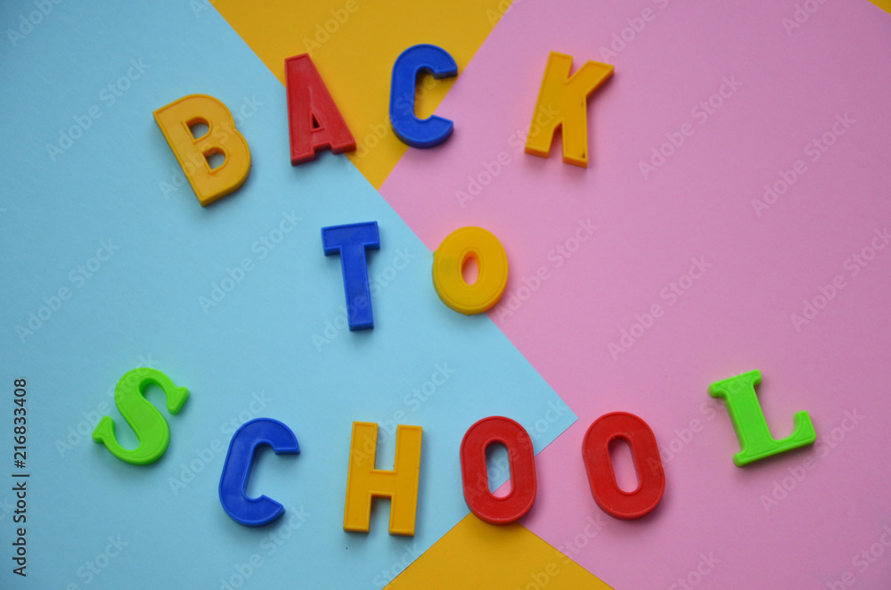 School office supplies with copy space. Back to school text concept. inscription flattering back to school on a colorful bright abstract Top view. School office supplies with copy space. Back to school text concept. inscription flattering back to school on a colorful bright abstract Top view.