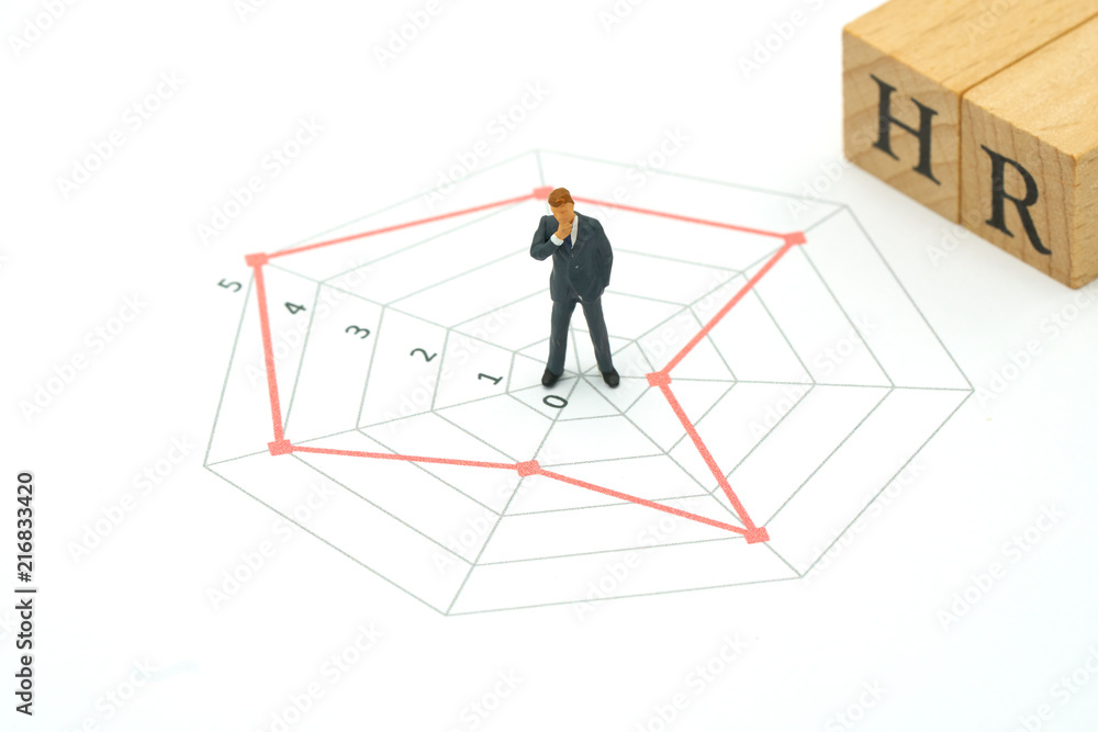 Miniature people businessmen standing on a Circle graphs of various skill levels. The concept used in selecting personnel to participate in the organization. with copy space. Miniature people businessmen standing on a Circle graphs of various skill levels. The concept used in selecting personnel to participate in the organization. with copy space.