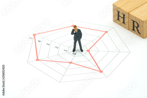 Miniature people businessmen standing on a Circle graphs of various skill levels. The concept used in selecting personnel to participate in the organization. with copy space.