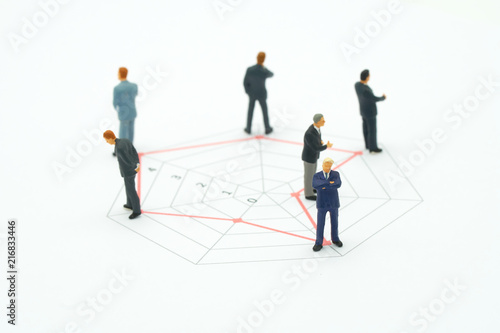 Miniature people businessmen standing on a Circle graphs of various skill levels. The concept used in selecting personnel to participate in the organization. with copy space. © zasabe