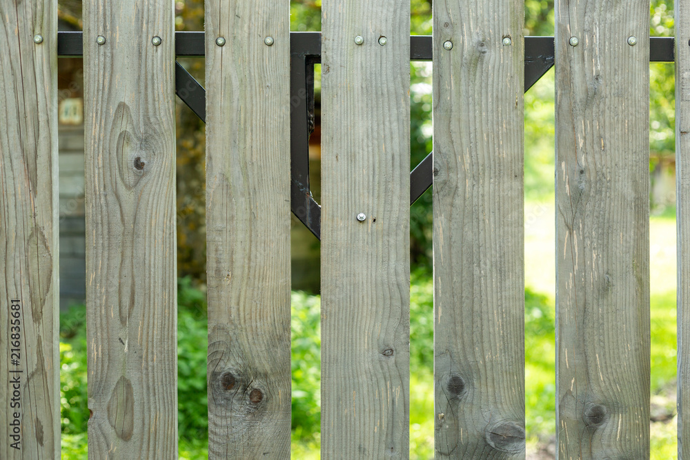 Fragment of old wooden fence outdoors.