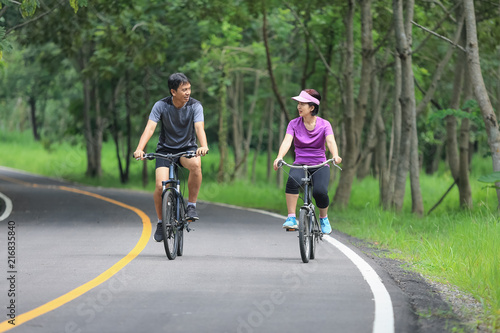 Wallpaper Mural Middle aged couple relaxing exercise with bicycle in park Torontodigital.ca