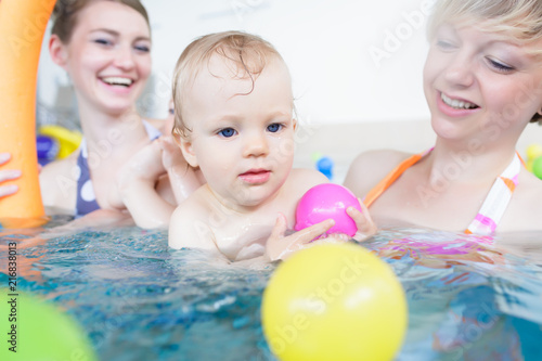 Mums being happy about their baby kids playing with each other in water
