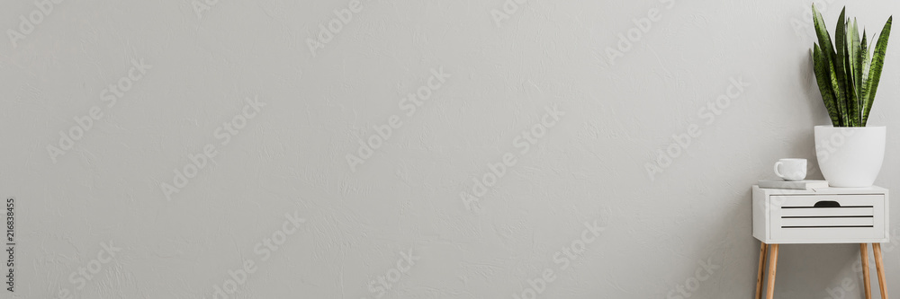 Plant on a white, scandinavian side table with wooden legs in a minimalist living room interior with gray wall and copy space place for furniture - obrazy, fototapety, plakaty 