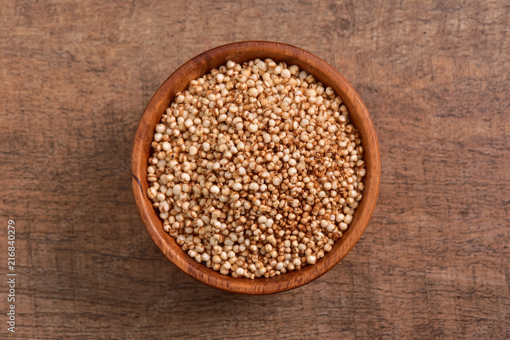 Sorghum seed bowl on wooden background Sorghum seed bowl on wooden background