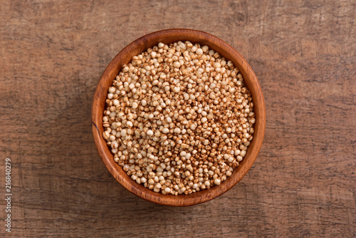 Sorghum seed bowl on wooden background