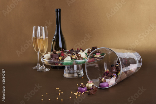Different types of small chocolate sweets whit wine and candle