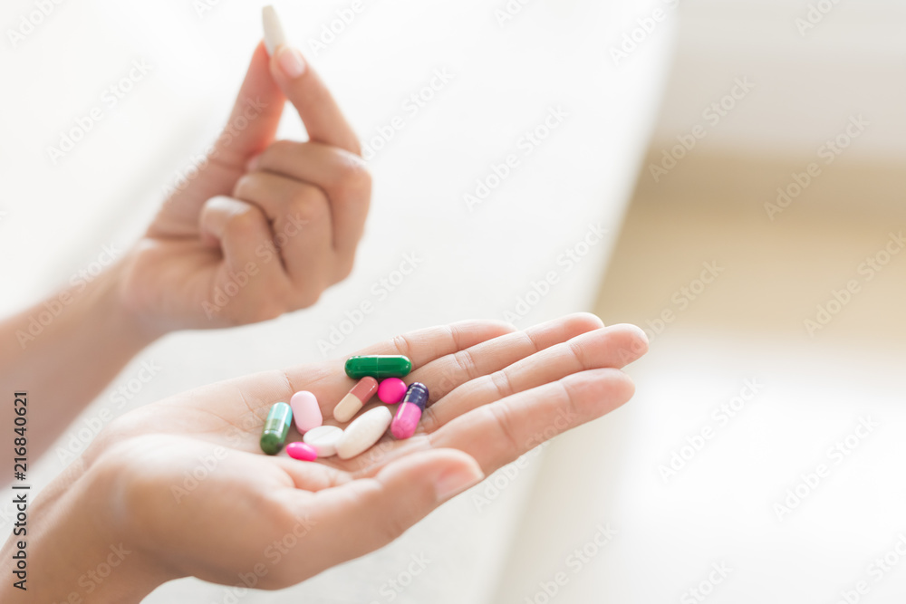 Woman hand with pills medicine tablets and capsule in her hands. Healthcare, medical supplements concept Woman hand with pills medicine tablets and capsule in her hands. Healthcare, medical supplements concept