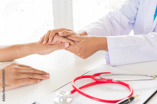 Doctor holding patient's hand. Medicine and health care concept. Doctor and patient.