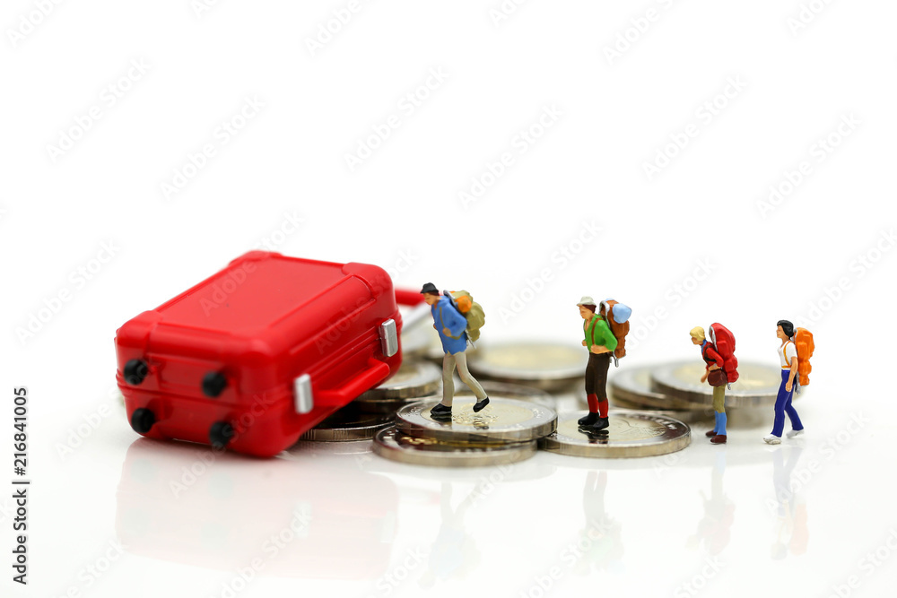 Miniature concept : Group of young traveler traveling / standing on coin Currency of the world,business trip traveler concept. Miniature concept : Group of young traveler traveling / standing on coin Currency of the world,business trip traveler concept.