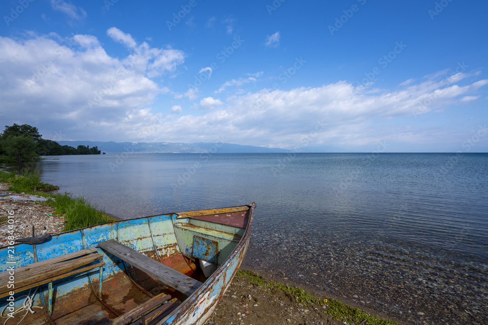 Obraz premium Lake Ohrid landscapes and Boat washed on beach in Macedonia
