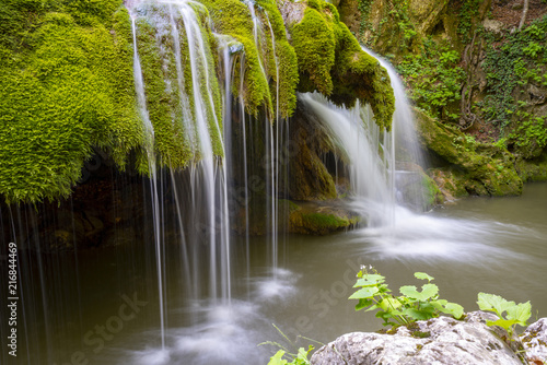 Beautiful unique Bigar Waterfall in Romania on the Edge of the Road passing through the carpatian Mountains