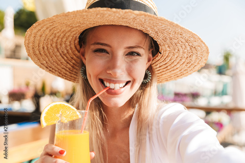 Delighted young girl in summer hat and swimwear