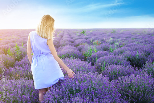 Fototapeta Naklejka Na Ścianę i Meble -  Young woman in lavender field on summer day
