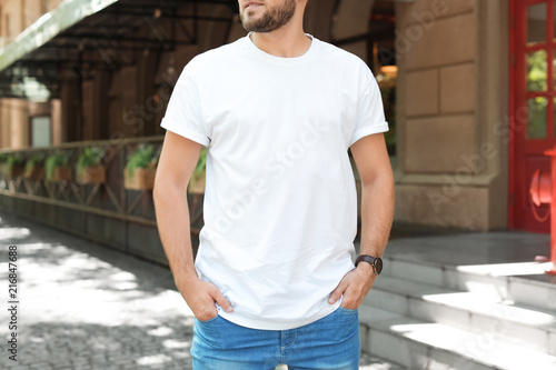 Young man wearing white t-shirt on street