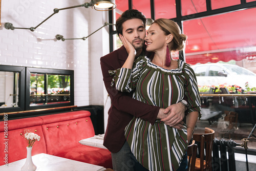 Tableau sur toile Hold me. Cheerful mature woman nestling man who hugging her