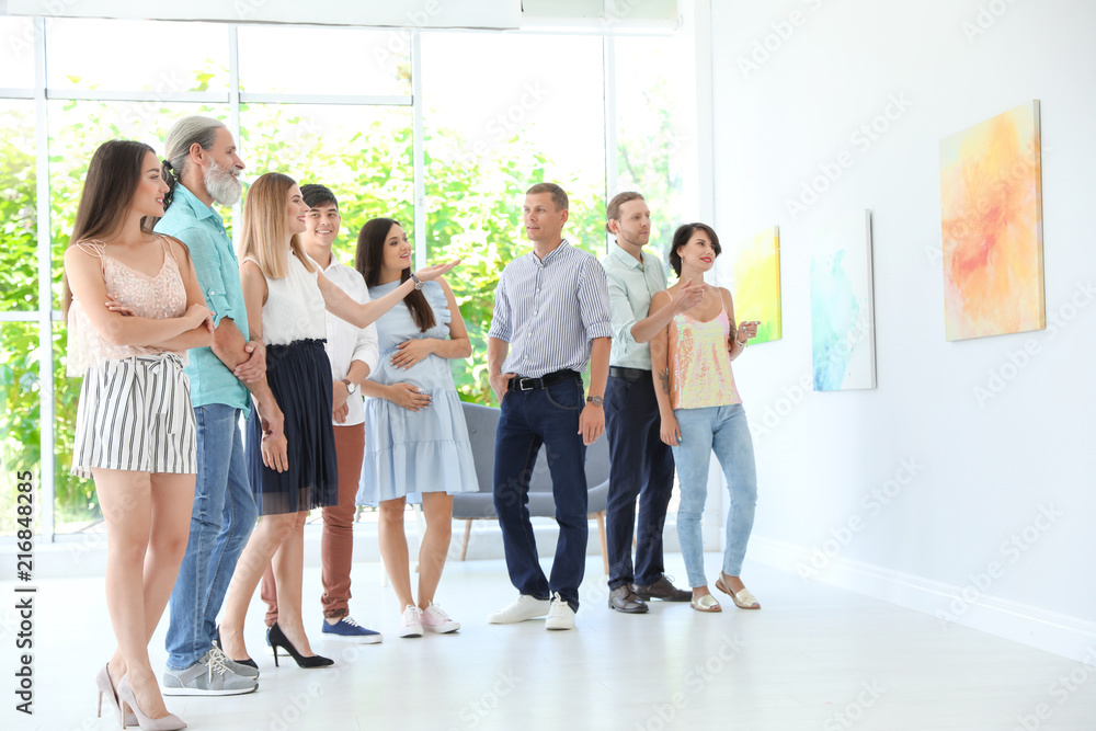 Fototapeta premium Group of people with guide at exhibition in art gallery