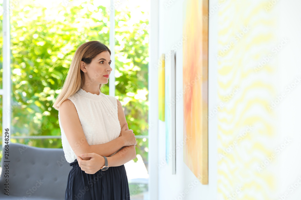 Beautiful woman at exhibition in art gallery Beautiful woman at exhibition in art gallery