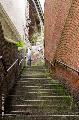 Deserted Narrow Stairway Between Brick Walls