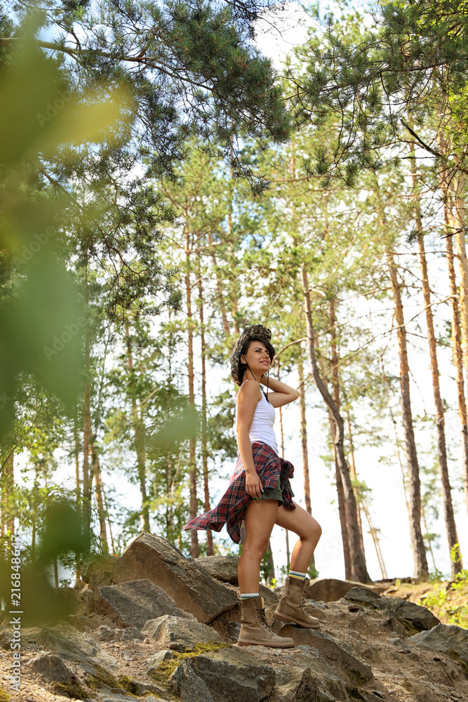Young woman in beautiful forest on summer day. Camping season Young woman in beautiful forest on summer day. Camping season