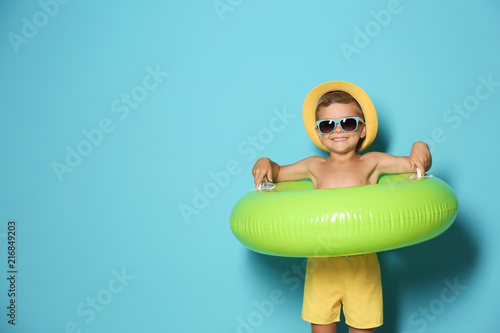Sticker Cute little boy with inflatable ring on color background