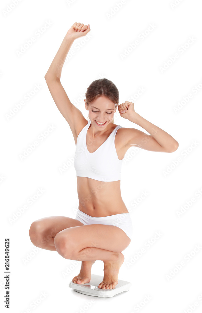 Happy young woman satisfied with her diet results using bathroom scales on white background Happy young woman satisfied with her diet results using bathroom scales on white background