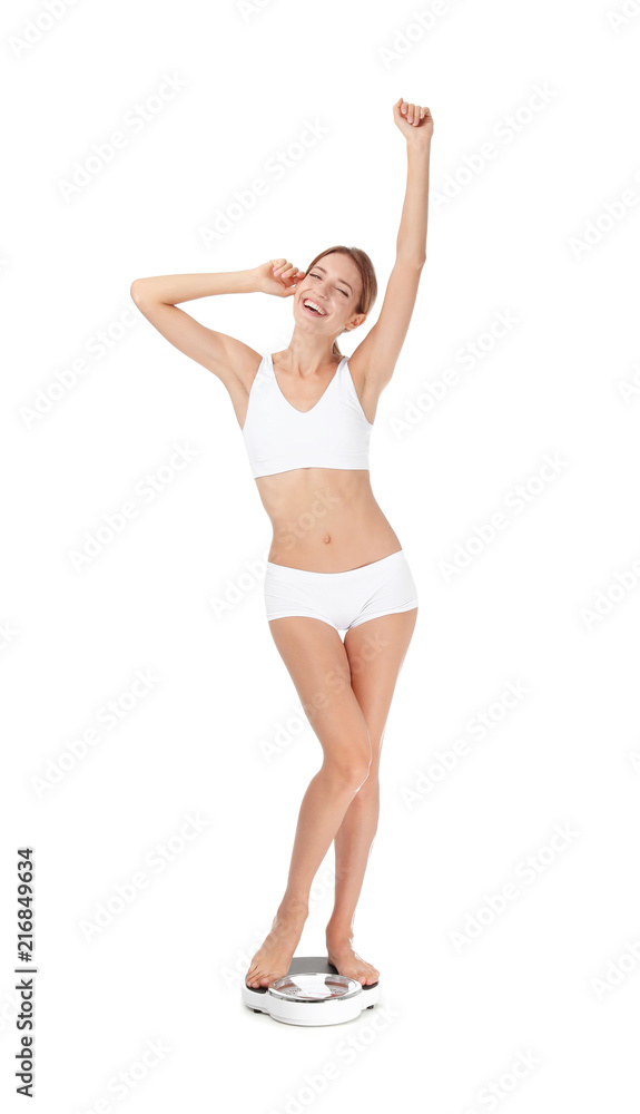 Happy young woman satisfied with her diet results using bathroom scales on white background Happy young woman satisfied with her diet results using bathroom scales on white background