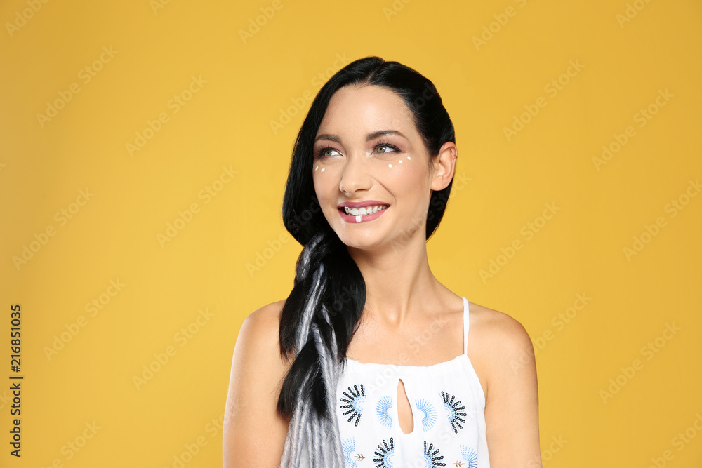 Portrait of young hippie woman with boho makeup in stylish outfit on color background Portrait of young hippie woman with boho makeup in stylish outfit on color background