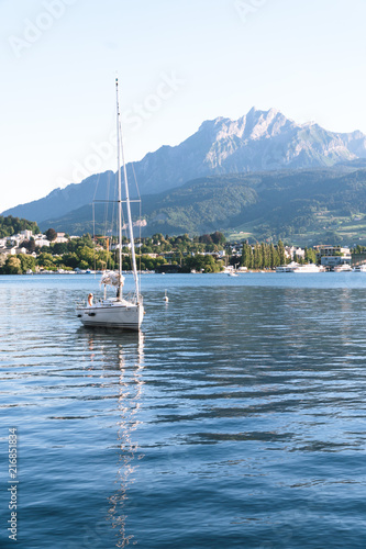 Mountain Pilatus and Sailing boat at Luzern, Switzerland, concept of travel vacation to Europe, vertical photo