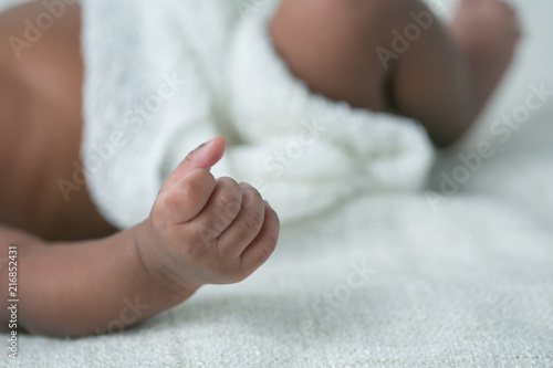 Awake Newborn Baby hands on Cream White Background