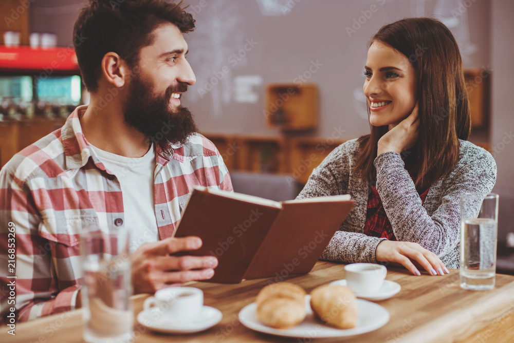 Attractive Young Couple Reading Book.