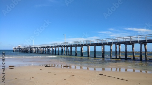 Long pier on shallow beach