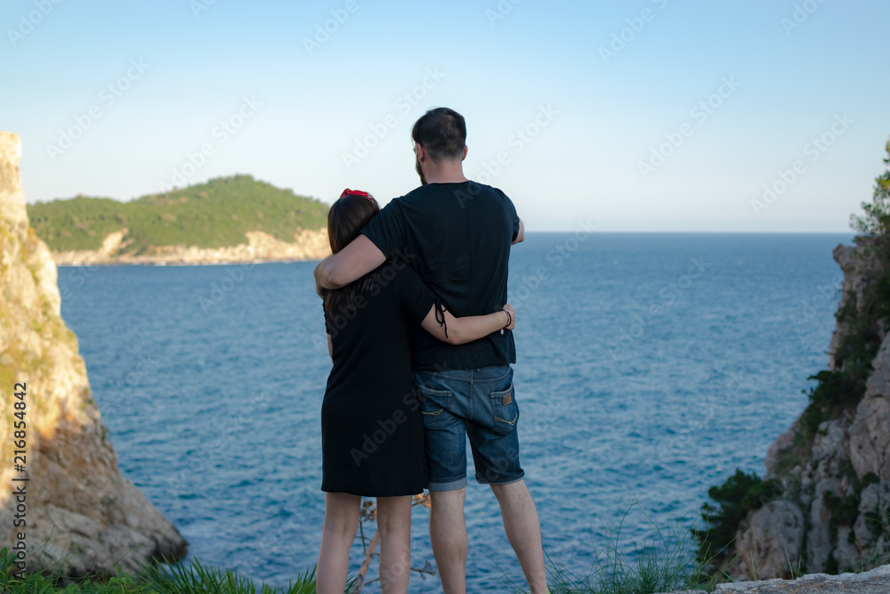 Image of a couple in love hugging looking at a beautiful seascape. Photograph taken in Dubronik, Croatia and the island of Otok Lokrum.