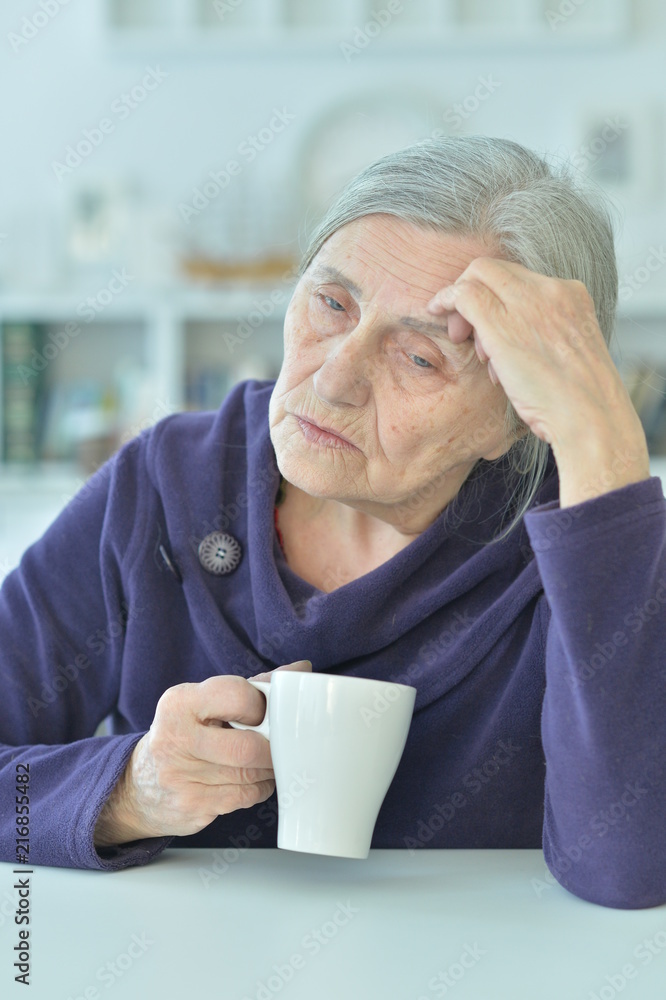 Portrait of a sad old woman drinking tea Portrait of a sad old woman drinking tea
