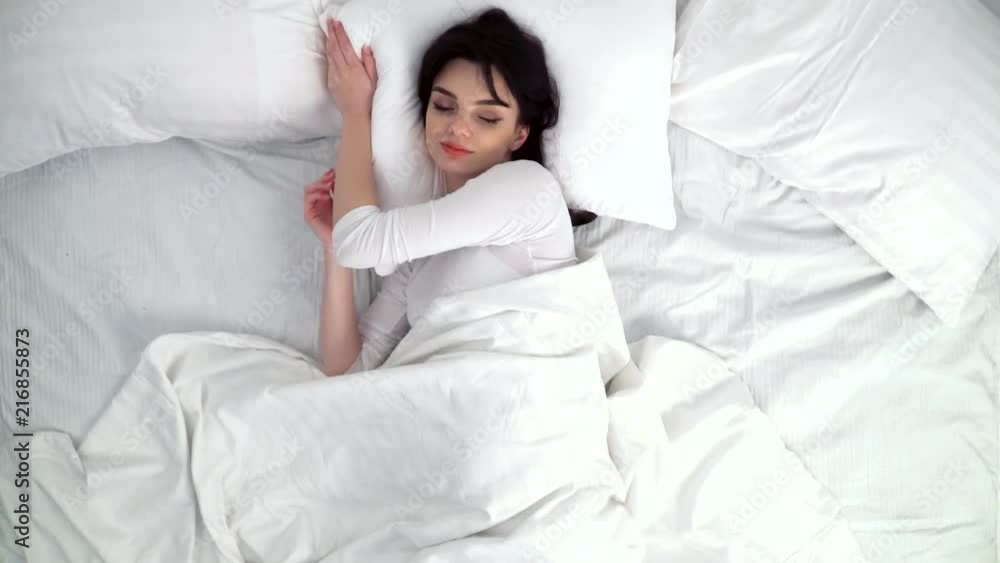 Woman Sleeping In Bed With White Linens At Home Woman Sleeping In Bed With White Linens At Home