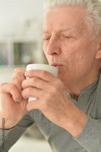 Portrait of beautiful senior man drinking tea