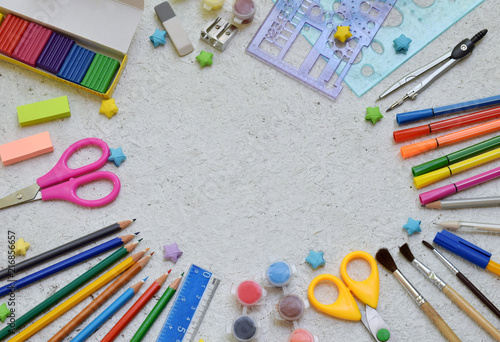 School accessories and supplies: pencils, markers, paint, pens, ruler on a light background. Back to school concept. Flat lay. Copy space