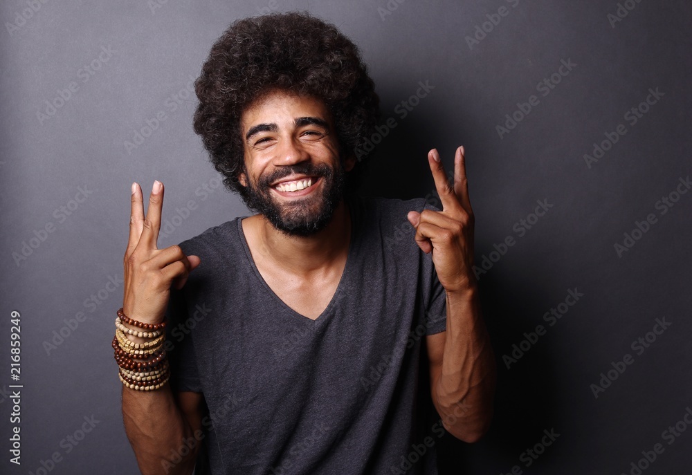 Afro man in front of a grey background Afro man in front of a grey background