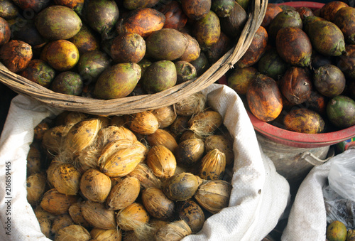 Areca nut aka betel nut at a market for sale. Paan is sold in ready-to-chew pouches called pan masala/ supari, as a mixture of many flavours whose primary base is areca nut crushed into small pieces photo