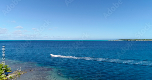 boat in a lagoon in French Polynesia, in aerial view © Fly_and_Dive
