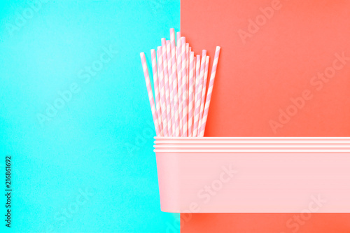 Stacked Drinking Paper Cups with Striped Straws on Duo Tone Mint Blue Crimson Background. Flat Lay. Birthday Party Celebration Kids Fun. Poster Template. Retro Vintage Colors. Glitch Pixel Stretch