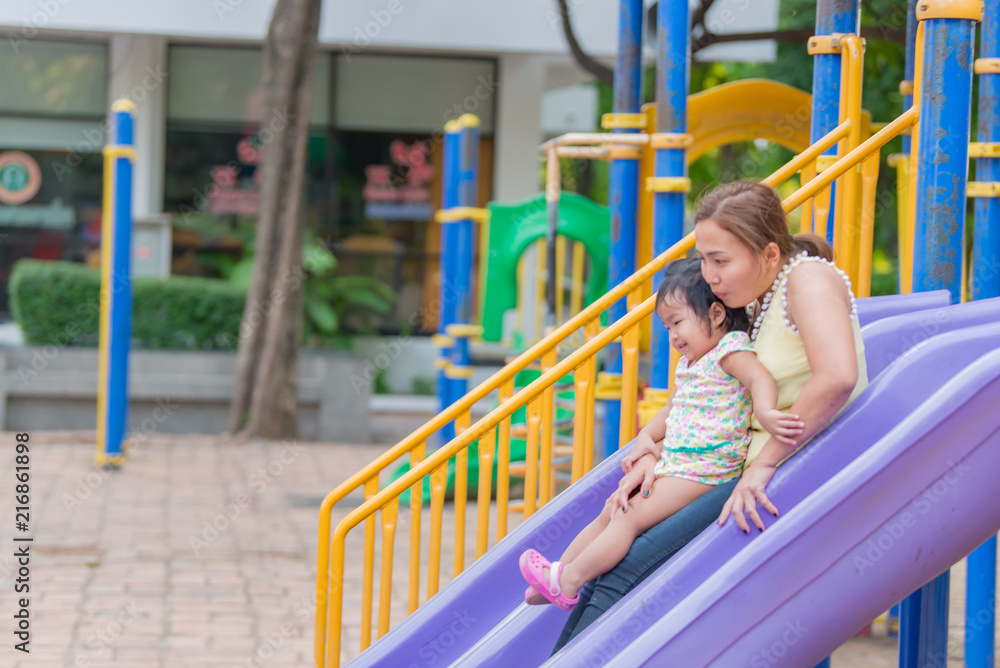 Beautiful young mother play with your daughter with fun at playground,Happy mother day,Thailand people