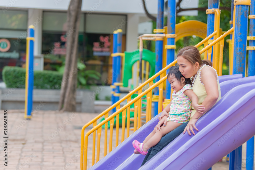 Obraz premium Beautiful young mother play with your daughter with fun at playground,Happy mother day,Thailand people