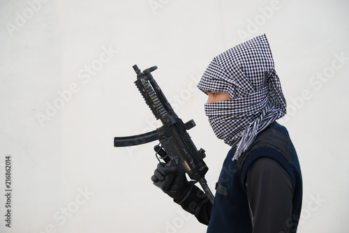 Close up terrorist with gun on white background,Thailand people,A bad guy,He is no good man photo