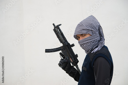 Close up terrorist with gun on white background,Thailand people,A bad guy,He is no good man photo